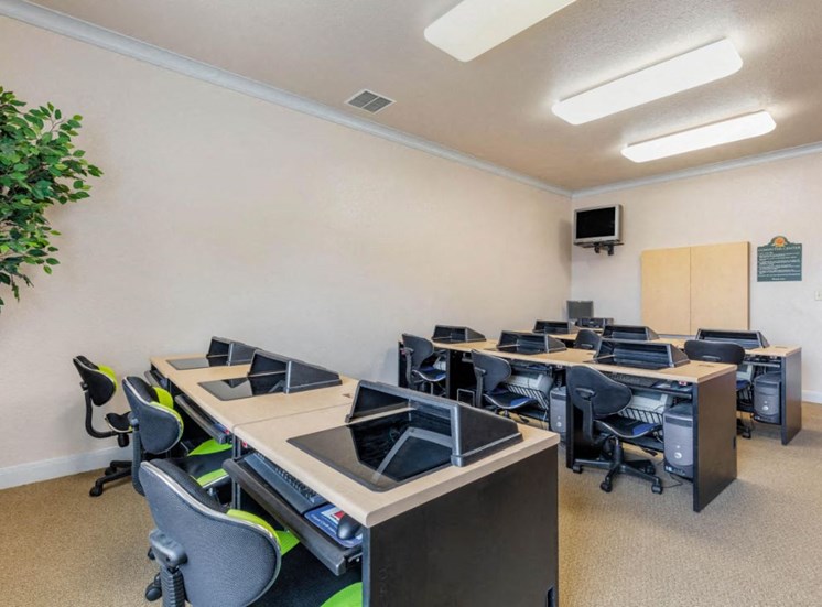 Computer lab with computers, desks, and chairs